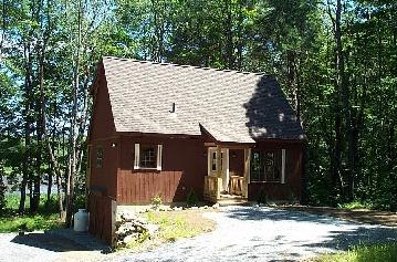 a view of a house with a yard and tree s