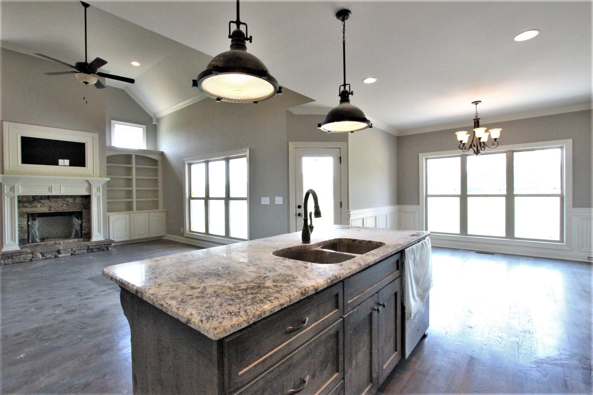 807 Philadelphia Road, Unit 3 Lebanon, TN 37087 - Photo 12 of 23 a kitchen with kitchen island granite countertop a stove and a wooden floor