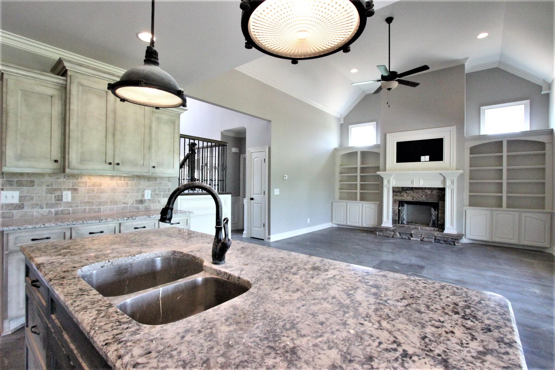 807 Philadelphia Road, Unit 3 Lebanon, TN 37087 - Photo 13 of 23 a kitchen with a stove a faucet a fireplace and a sink with wooden floor