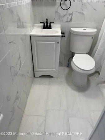 a white toilet sitting next to a bathroom sink