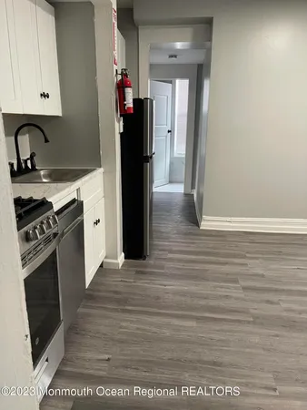 a kitchen with a refrigerator and a stove