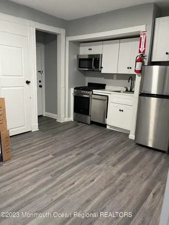 a kitchen with stainless steel appliances a refrigerator sink and stove