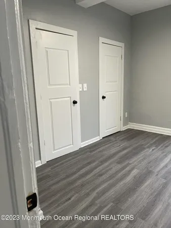 an empty room with wooden floor