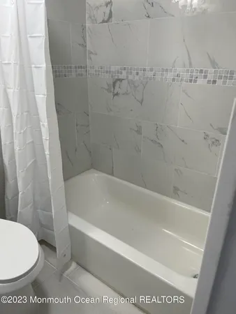 a bath tub sitting next to a white toilet