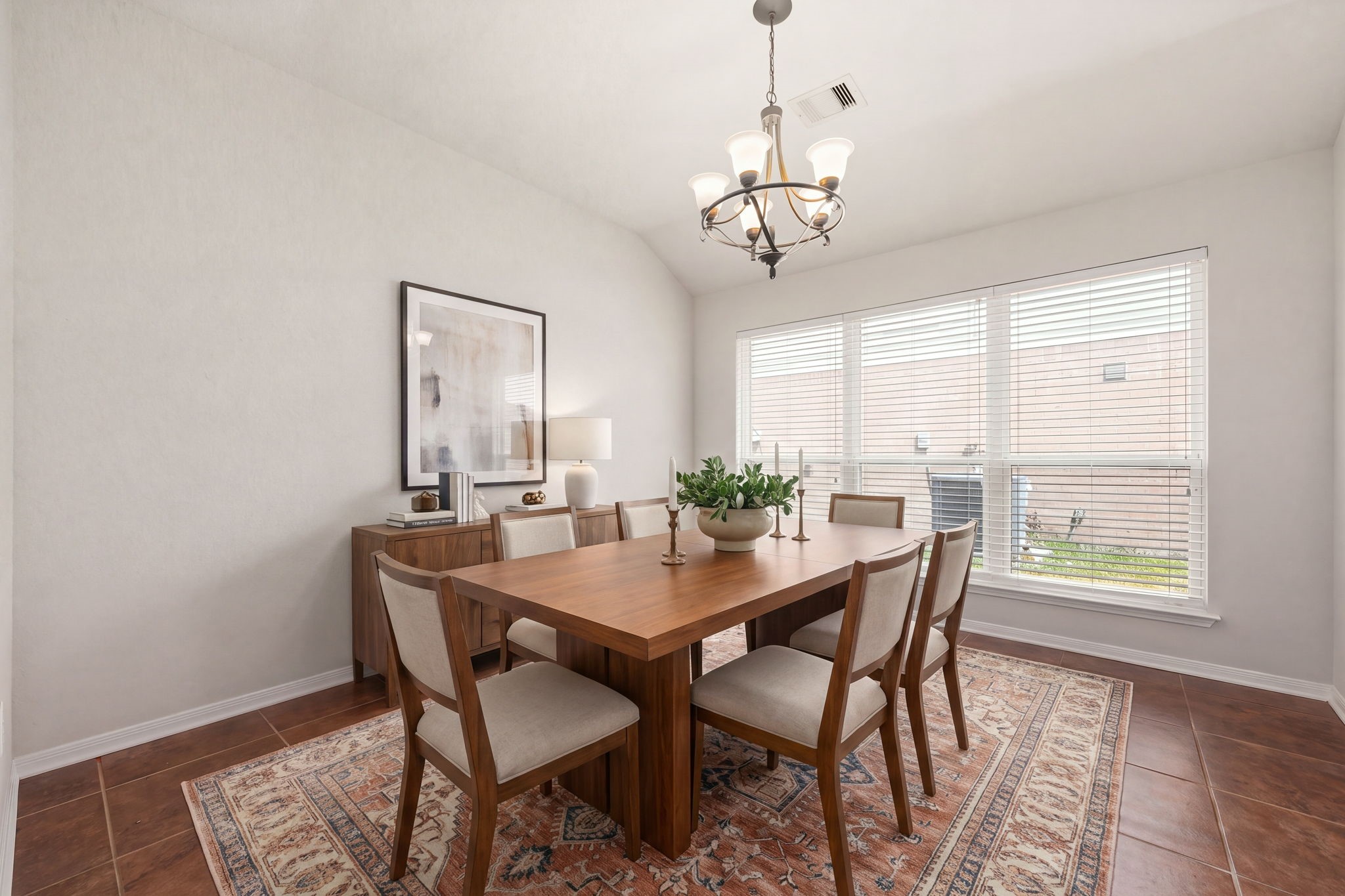 3102 Single Ridge Way Katy, TX 77493 - Photo 11 of 23 Elegant formal dining room featuring high, vaulted ceilings and an attractive central chandelier that adds a sophisticated touch to the space. Low-maintenance tile flooring flows throughout, while an impressive bank of wide windows brings in ample natural light, making it an excellent setting for hosting family meals and special occasions. *Virtually Staged