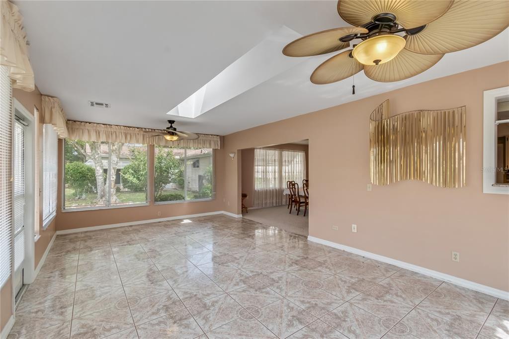 8156 Southwest 108th Ln Road Ocala, FL 34481 - Photo 16 of 50 a view of an empty room with window and chandelier fan