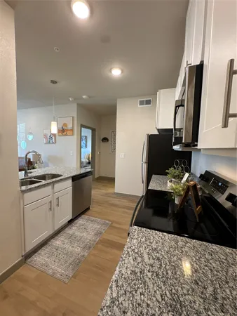 a kitchen with a sink appliances and cabinets