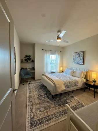a spacious bedroom with a bed and a chandelier
