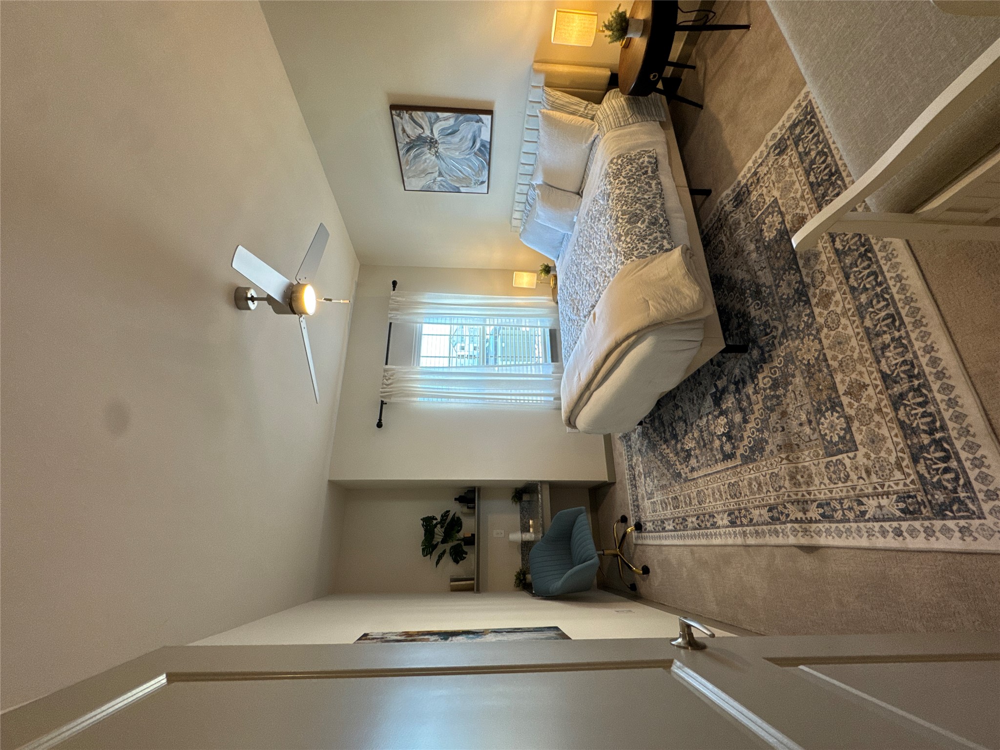 691 Union Chapel Road, Unit A1 Cedar Creek, TX 78612 - Photo 10 of 14 a spacious bedroom with a bed and a chandelier