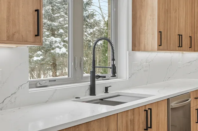a kitchen with granite countertop a sink and cabinets