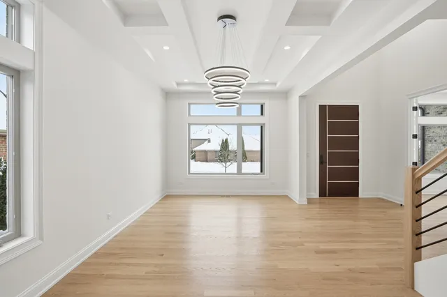 a view of a hallway with wooden floor and entryway