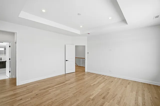 a spacious bathroom with a double vanity sink mirror and a bathtub