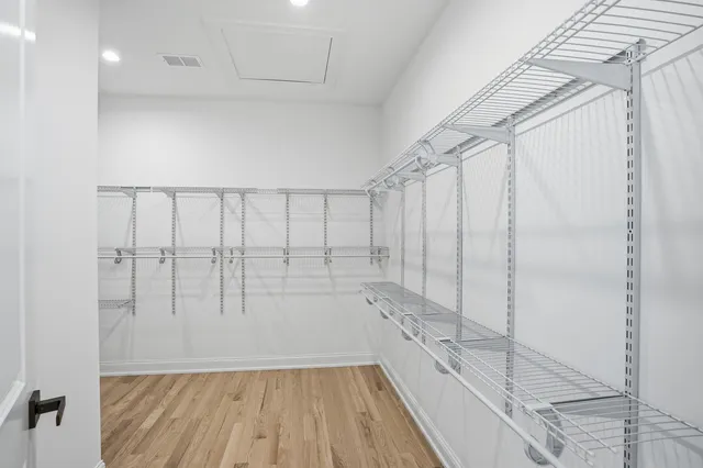 a bathroom with a double vanity sink a mirror and a bathtub