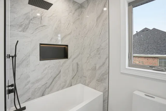 a view of a hallway with stairs and wooden floor