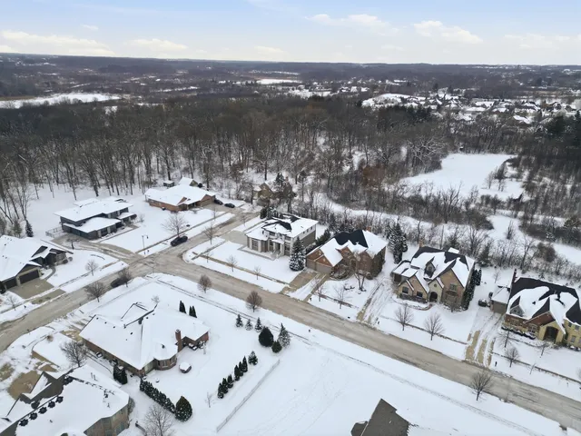 an aerial view of a houses with yard