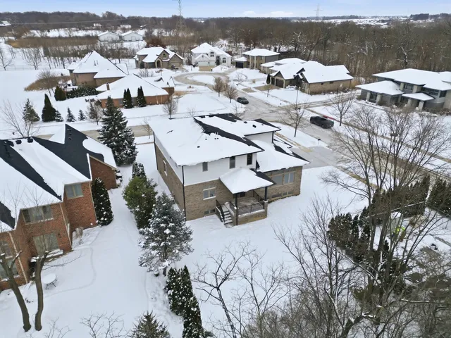 a front view of a house with yard and parking