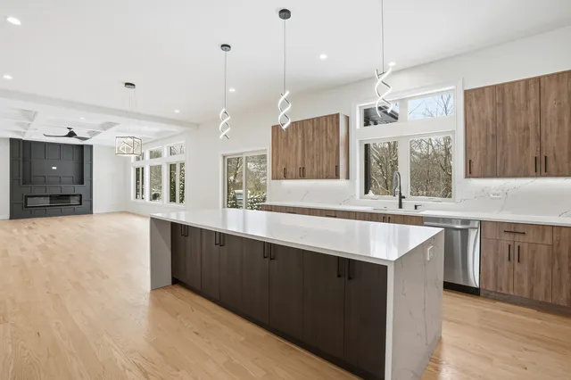 a large kitchen with a sink and a refrigerator