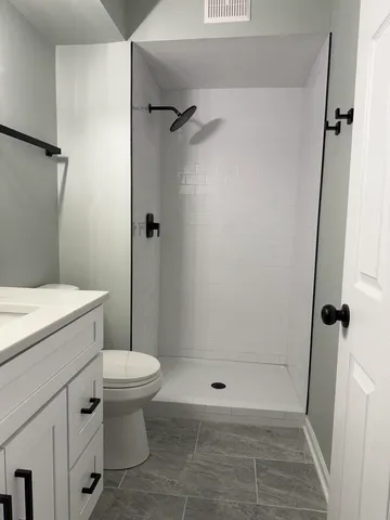 a bathroom with a shower and a toilet