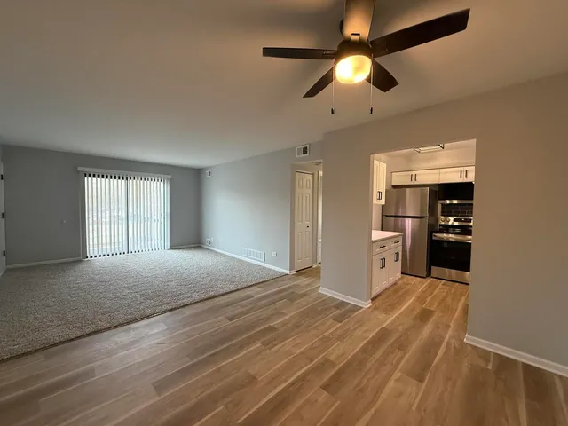 a kitchen with kitchen island white cabinets and stainless steel appliances
