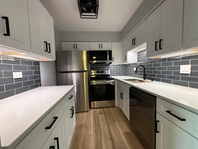 a kitchen with a sink a stove and refrigerator