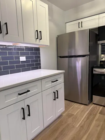 a kitchen with cabinets and stainless steel appliances