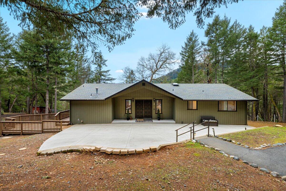 350 Splendor Drive Wilderville, OR 97543 - Photo 3 of 57 a front view of a house with a yard and trees