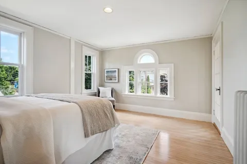 a spacious bedroom with a large bed and a large window