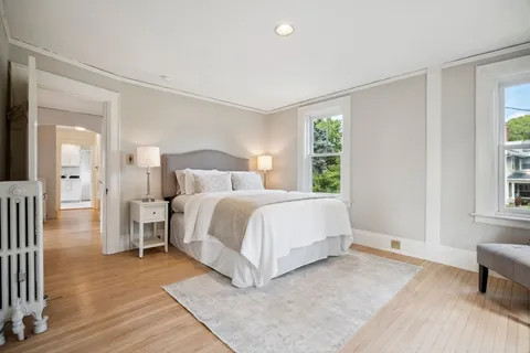 a spacious bedroom with a bed and a window