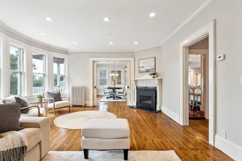 a living room with fireplace furniture and a wooden floor