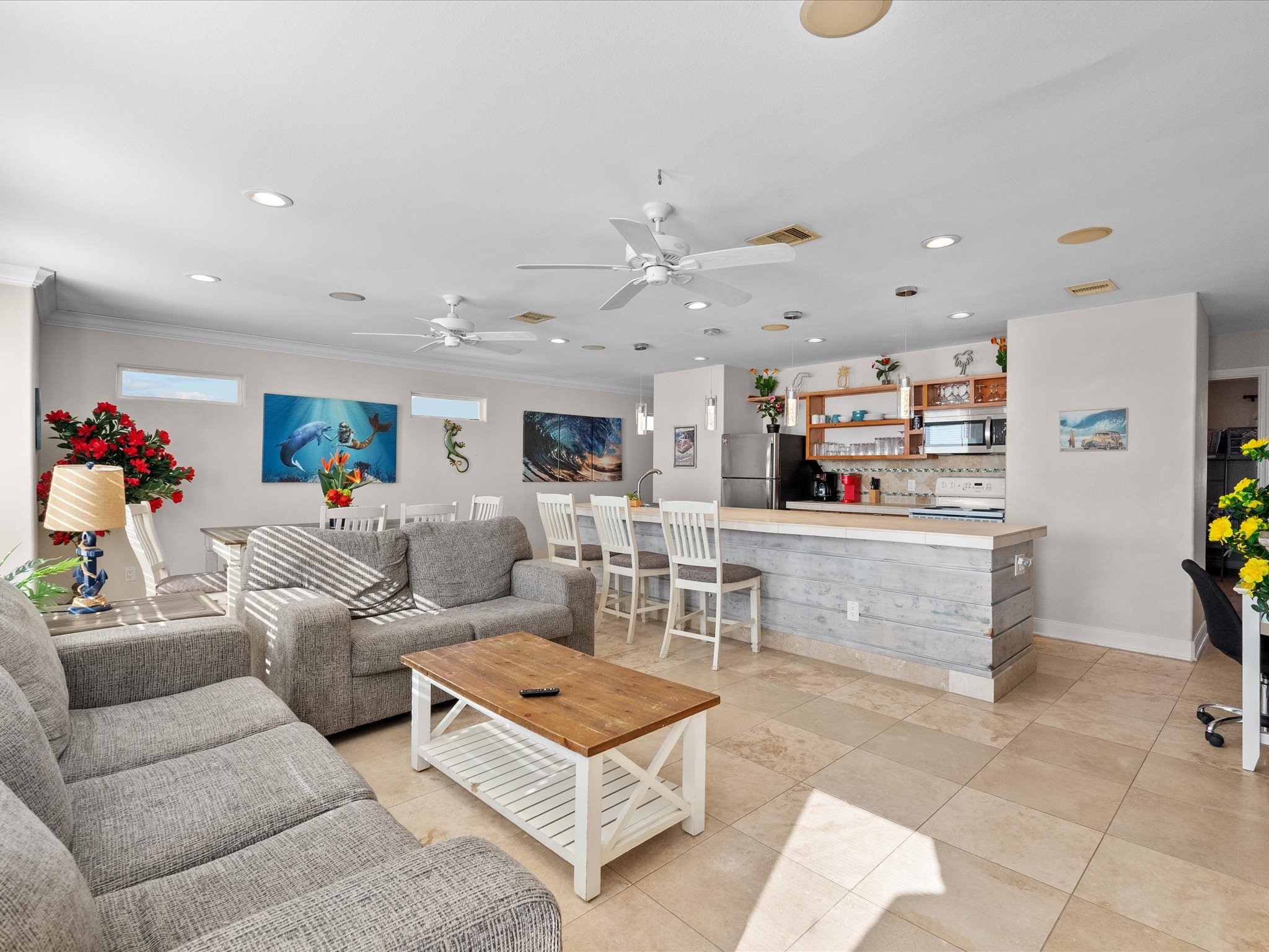 111 Beach Drive Surfside Beach, TX 77541 - Photo 22 of 31 a living room with furniture and a dining table with kitchen view