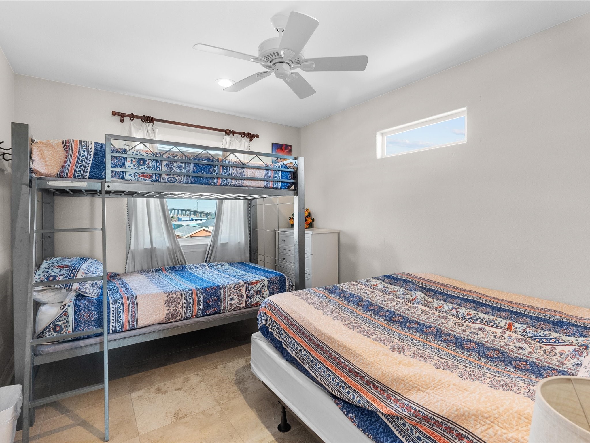 111 Beach Drive Surfside Beach, TX 77541 - Photo 30 of 31 a bedroom with a bed and a chandelier