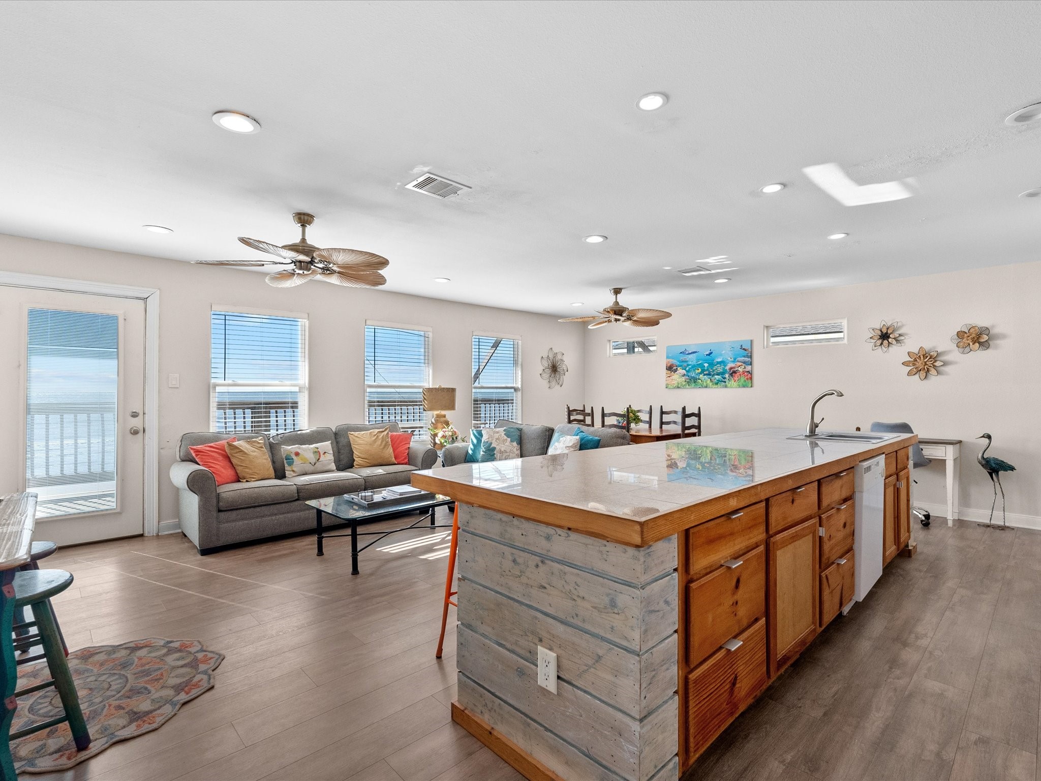 111 Beach Drive Surfside Beach, TX 77541 - Photo 6 of 31 a living room with kitchen island furniture and a chandelier