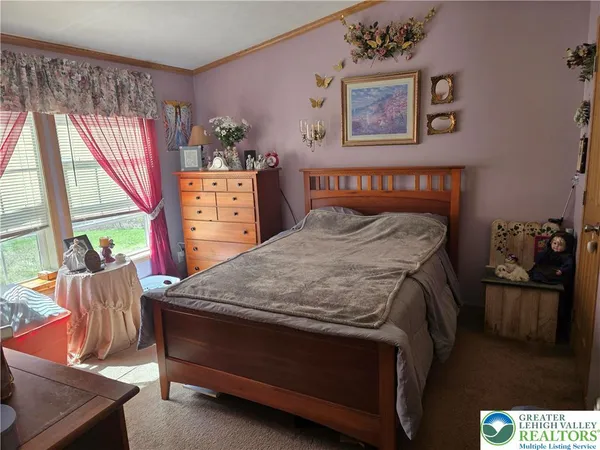 a bed sitting in a bedroom next to a window