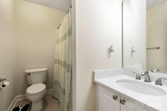 a bathroom with a toilet sink and a mirror