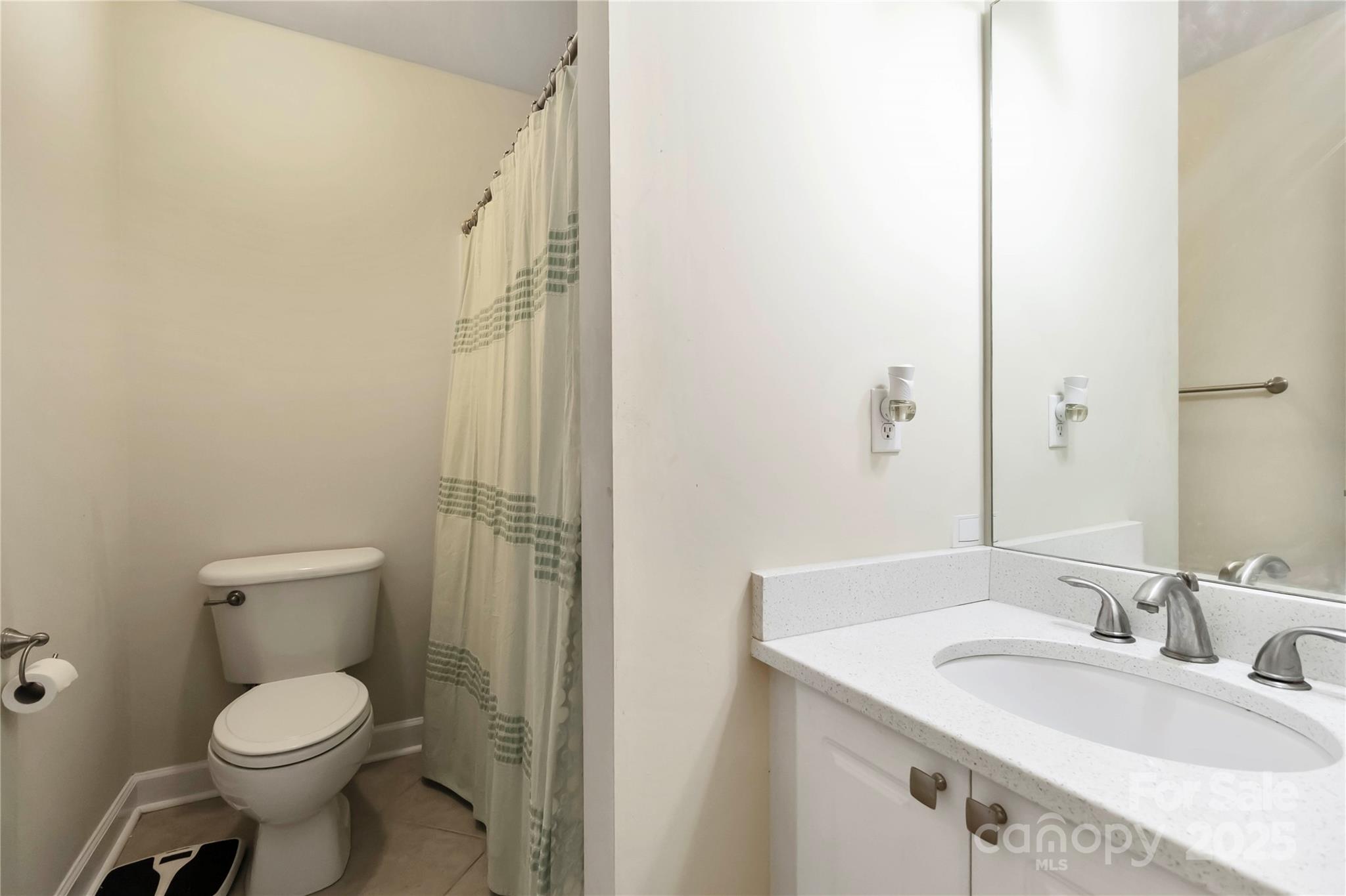 2127 Genesis Drive Monroe, NC 28110 - Photo 11 of 17 a bathroom with a toilet sink and a mirror