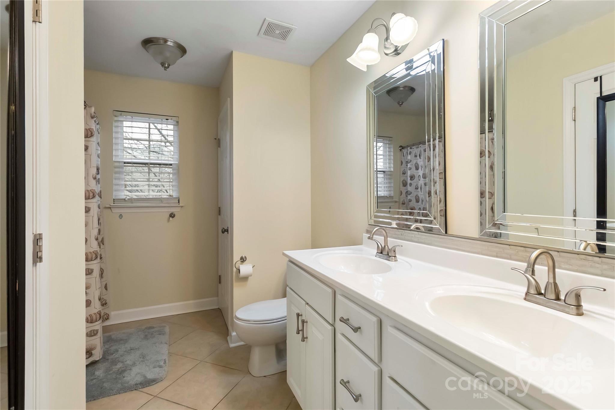 2127 Genesis Drive Monroe, NC 28110 - Photo 14 of 17 a bathroom with a sink a toilet and shower