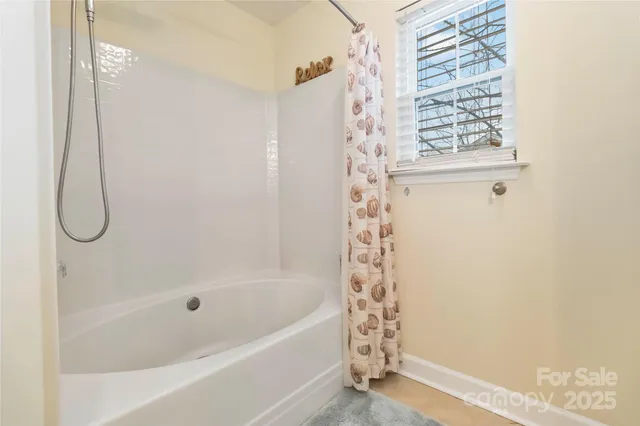 a bathroom with a bath tub and shower