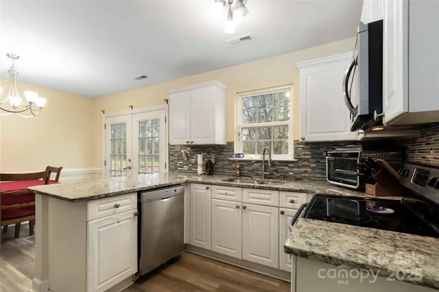 a kitchen with a sink stove and cabinets
