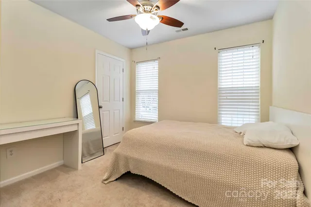 a bedroom with a bed and a large window