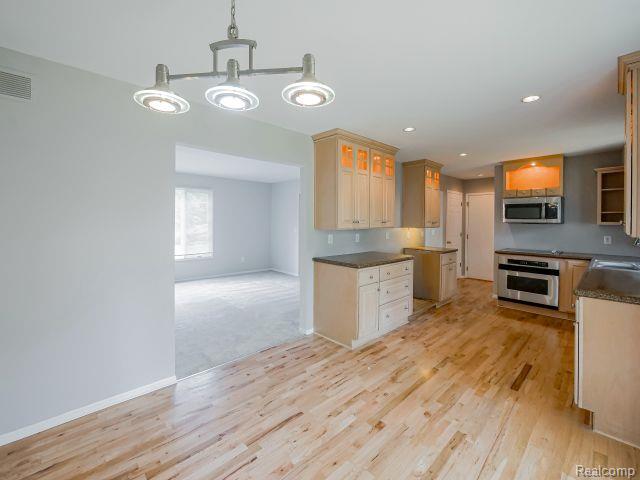 21728 Ruth Street Farmington, MI 48336 - Photo 13 of 54 Kitchen featuring light wood-finish cabinetry, dark countertops, recessed lighting, and stainless steel appliances