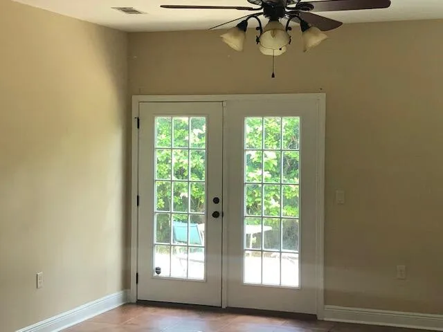 a kitchen with granite countertop a refrigerator and a sink