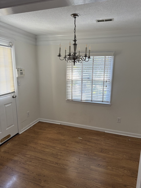 577 Adams Street, Unit D Milton, MA 02186 - Photo 5 of 11 an empty room with wooden floor cabinet and windows