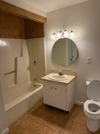 a bathroom with a sink a toilet and bathtub