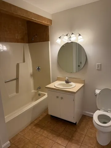 a bathroom with a sink a toilet and bathtub