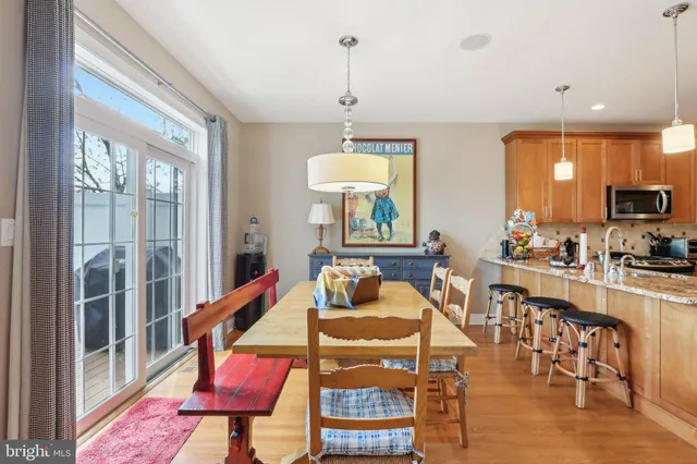 a dining room with furniture a chandelier and wooden floor