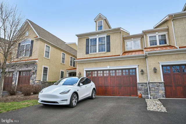 a car parked in front of a brick house