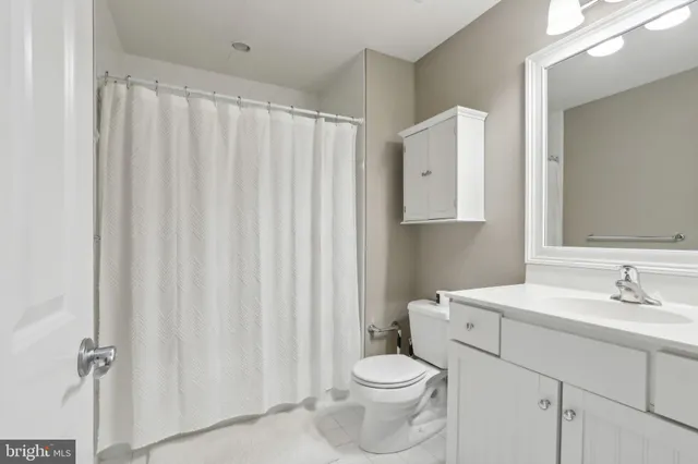 a bathroom with a toilet a sink and a mirror