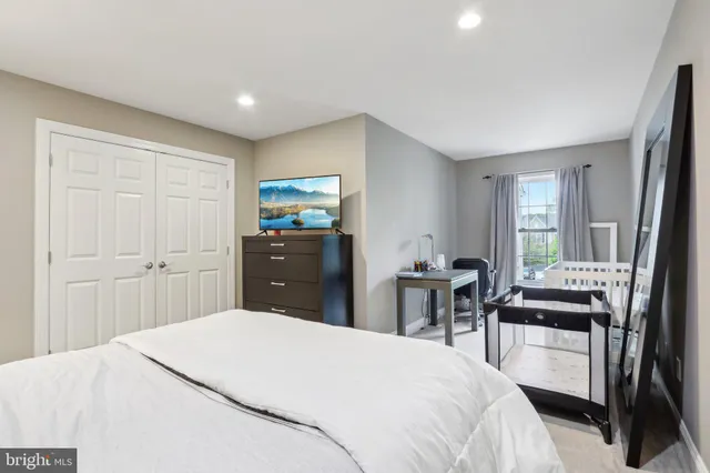 a bedroom with a bed and a dresser in it