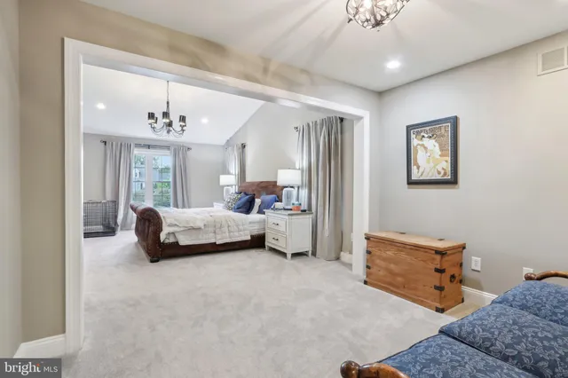 a bedroom with furniture and a chandelier