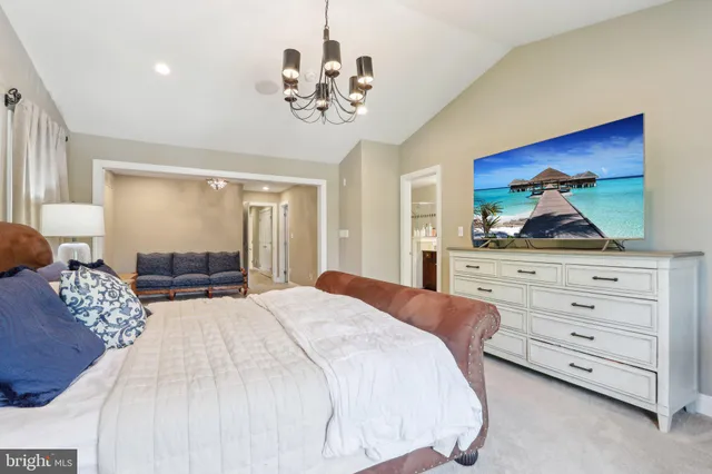 a bedroom with a large bed and a dresser